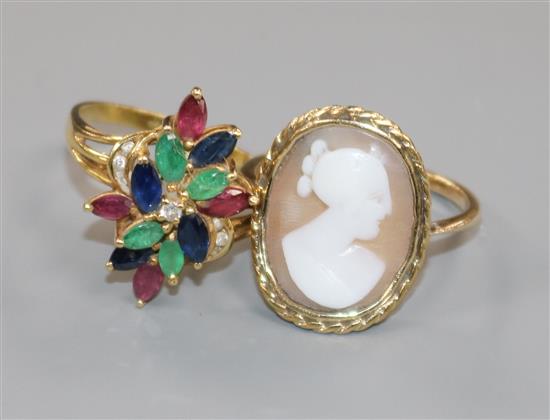 An 18k and multi gem set cocktail ring and a yellow metal and cameo ring.